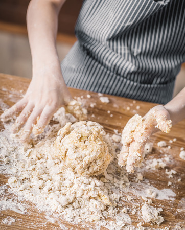 Hands of girl making doughの写真素材