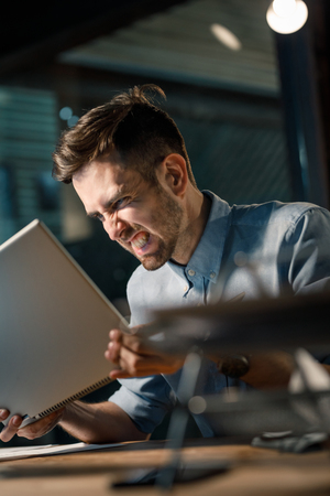 Furious man yelling at computerの写真素材