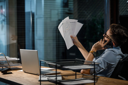 Office worker with papers having call