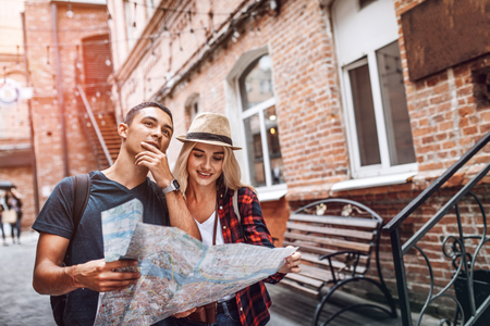 Casual couple searching for route on streetの写真素材