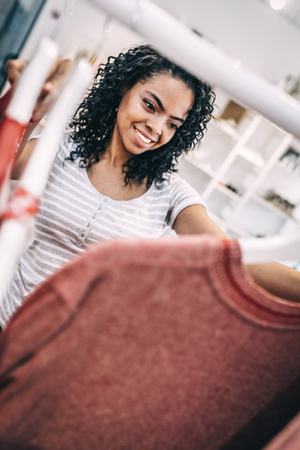 Relaxed woman shopping in clothes storeの写真素材
