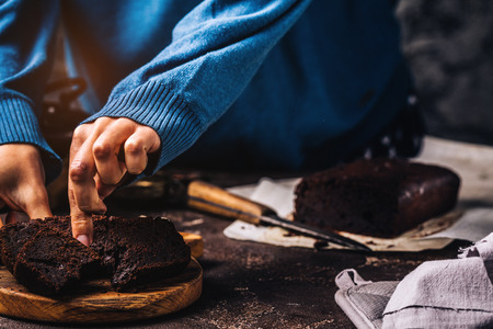 Crop woman serving moist chocolate cake