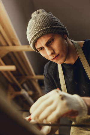 Focused carpenter making marks on plankの写真素材