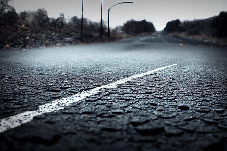 Low angle of horror spooky country road or asphalt urban highway going into the distance atmospheric nightmare mood grunge abstract background. Foggy avenue roadside wallpaperの素材