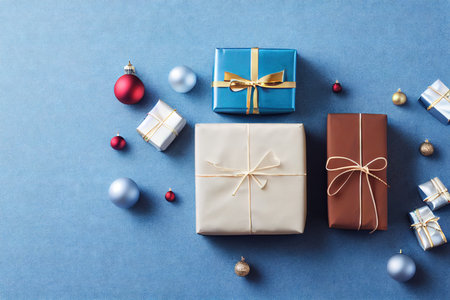 Christmas gift boxes handmade stack in package on blue backgroundの素材
