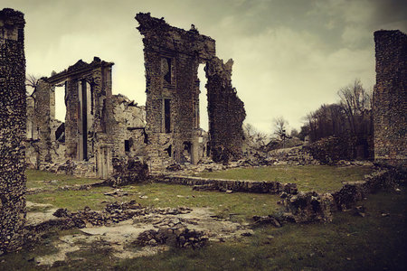 Crumbling and overgrown walls of destroyed industrial building from scratchの素材