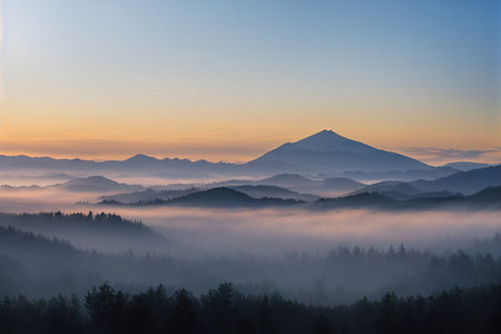 Distant snow-covered hills and mysterious misty forest in foregroundの素材
