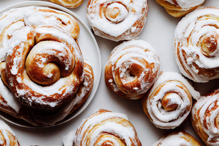 Golden hot cinnamon buns with white cream coatingの素材