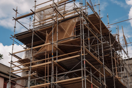a scaffold in the process of being raised, with ropes and metal hooks visible, created with generative aiの素材