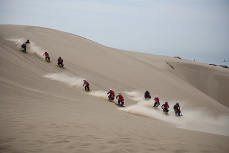 team of sandboarders racing down dune, with the finish line in sight, created with generative aiの素材