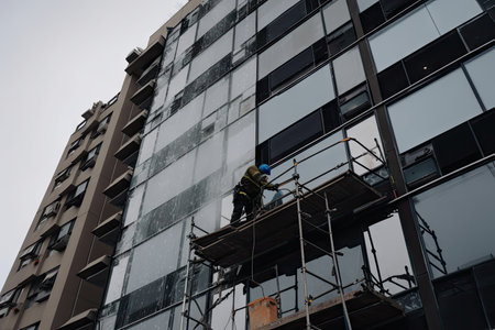 scaffolding being used to repair cracked window on a tall building, created with generative aiの素材