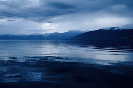 dark blue water, with reflections of mountains and sky, created with generative aiの素材