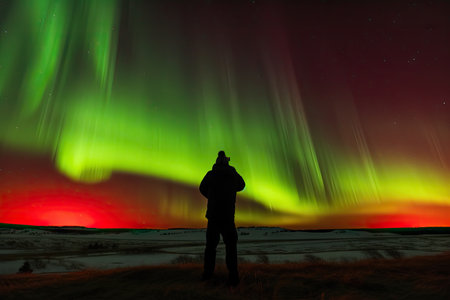 person, capturing the incredible aurora borealis and australis, with silhouette of person visible, created with generative aiの素材