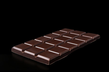 chocolate bar on black background with copy space for your own advertisement, created with generative aiの素材