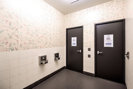 gender-neutral restroom with inclusive signage and accessories, including a toiletries kit, created with generative aiの素材