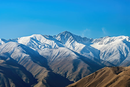 majestic mountain range, with snowcapped peaks and clear blue skies, created with generative aiの素材