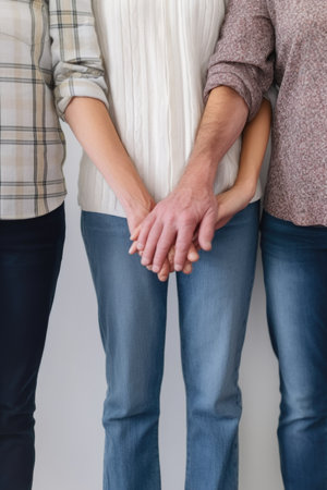 cropped shot of four unrecognizable people standing hand in hand, created with generative aiの素材