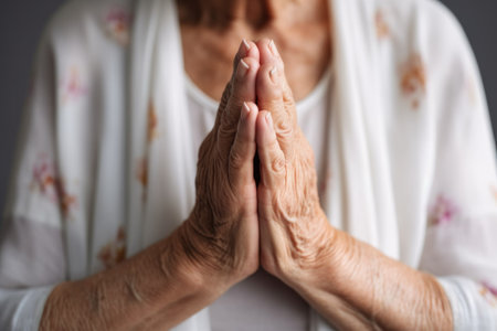closeup of a senior woman standing with her hands together in prayer on the yoga mat, created with generative aiの素材