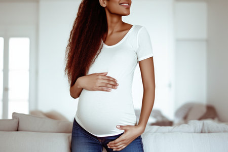 shot of a pregnant woman holding her belly at home, created with generative aiの素材