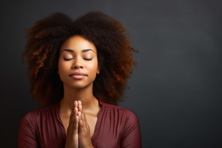 woman with eyes closed in prayer positionの素材