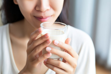 asian female taste-testing homemade almond milkの素材