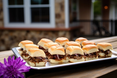 tray of bbq sliders at picnic tableの素材