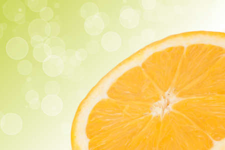 Half orange on green backgroundの写真素材