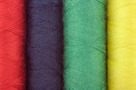 close up of colorful spools of thread