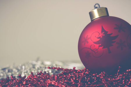 Christmas ball with a red and silver backgroundの写真素材