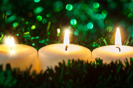 Christmas candle on green backgroundの写真素材