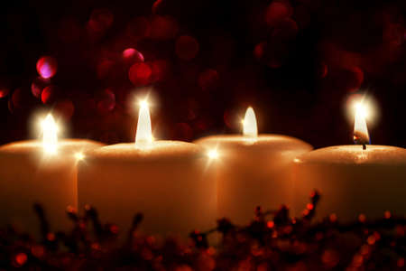 glittering candle flame on red backgroundの写真素材
