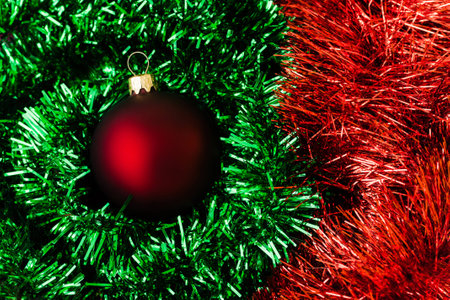 Red Christmas ball on a green backgroundの写真素材