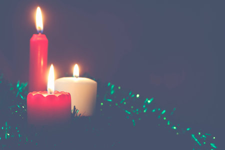 three candles on a green backgroundの写真素材