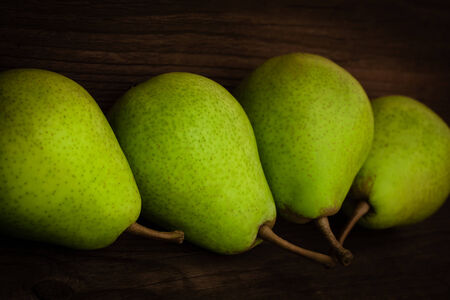 green pear on a wooden backgroundの写真素材