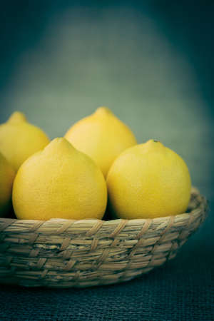 lemons in a straw basketの写真素材