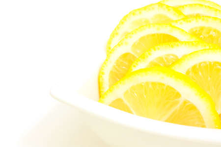 lemon slices in a white bowlの写真素材
