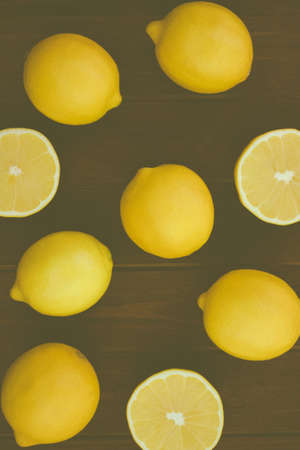 yellow lemons on a wooden board in the styleの写真素材