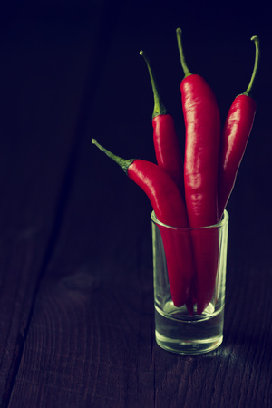 chilli peppers on wooden backgroundの写真素材