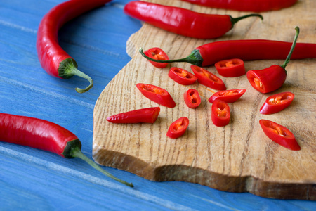 chopped red pepper on wooden plateの写真素材