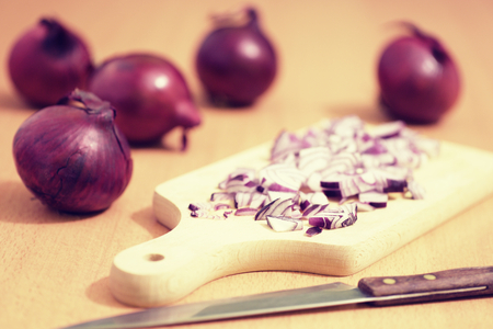 sliced red onion with a knifeの写真素材