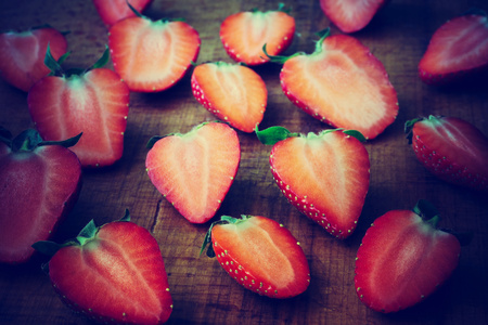 sliced strawberries on a wooden backgroundの写真素材