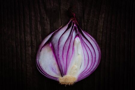 halved red onion on wooden backgroundの写真素材