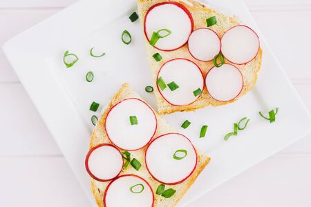 Bread with radish on a white plateの写真素材