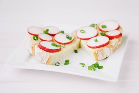 Bread with radish on a white plateの写真素材