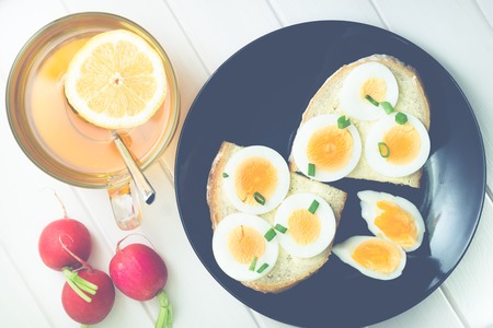 bread with egg on a black plateの写真素材