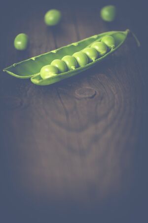 green peas on a wooden background