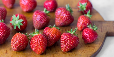 wooden tray with red strawberriesの写真素材