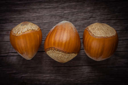 three hazelnuts on wooden backgroundの写真素材
