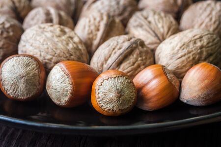 mixed nuts on a black plateの写真素材