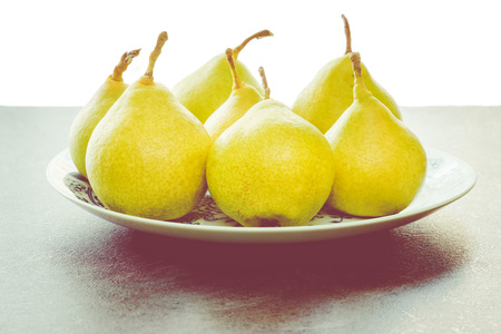 yellow pear on a plateの写真素材